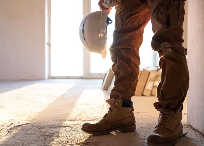 man-builder-with-helmet-his-hands-copy-space